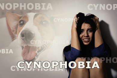 Scared young woman suffering from cynophobia on white background. Irrational fear of dogs