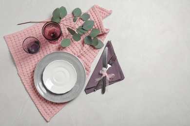 Stylish elegant table setting on light background, top view. Space for text