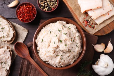 Photo of Delicious lard spread served on wooden table, flat lay
