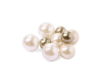 Many beautiful oyster pearls on white background