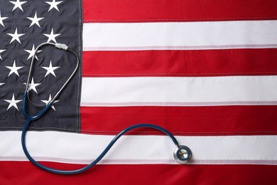 Stethoscope on American flag, top view. Space for text