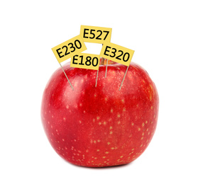 Fresh apple with E numbers isolated on white. Harmful food additives 