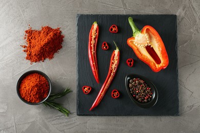 Flat lay composition with paprika powder on grey table
