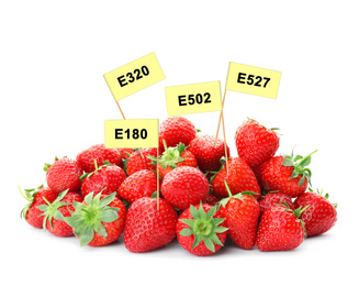 Ripe strawberries with E numbers on white background. Harmful food additives 
