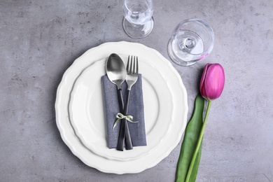 Stylish elegant table setting on grey background, top view
