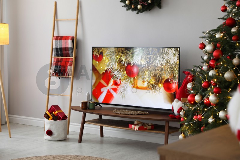 Stylish living room interior with modern TV and Christmas tree