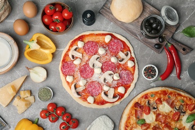 Composition with unbaked pizza and ingredients on table, top view