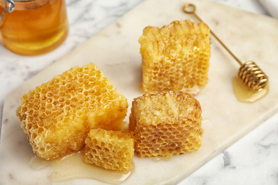 Fresh delicious sweet honeycombs on white board