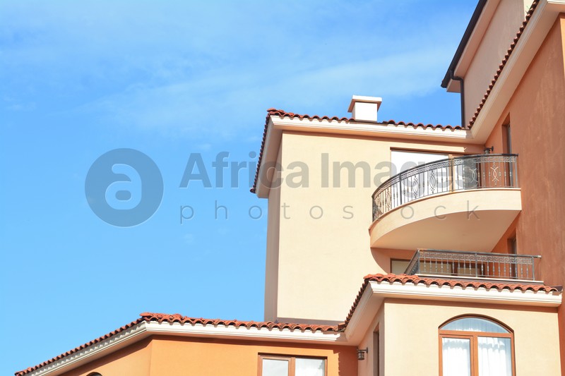 Photo of Exterior of beautiful residential buildings with balconies against blue sky