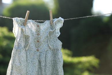 Dress drying on washing line against blurred background