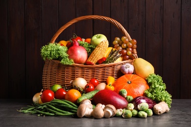 Assortment of fresh organic fruits and vegetables on grey table
