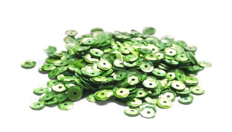Photo of Pile of green sequins isolated on white