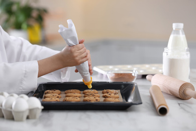 Female chef preparing biscuits at kitchen table, closeup. Cooking delicious food