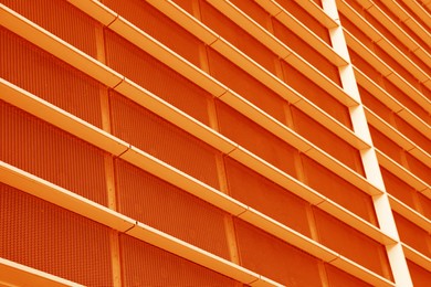 Modern building, low angle view. Toned in orange color
