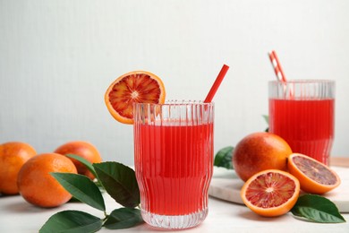 Tasty sicilian orange juice and fruits on white wooden table