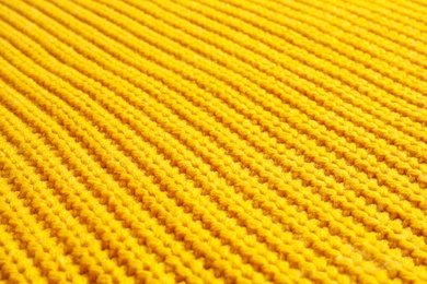 Yellow winter sweater as background, closeup view