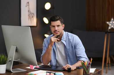Male designer working at desk in office