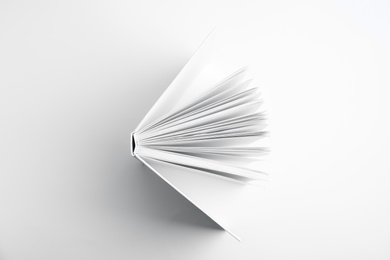 Open book with hard cover on white background, top view