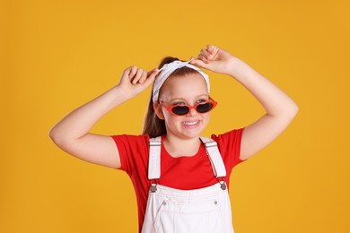 Cute indie girl with sunglasses on yellow background