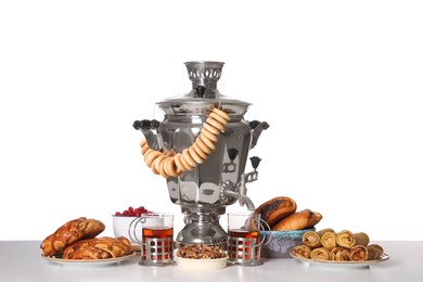 Photo of Traditional Russian samovar with treats isolated on white