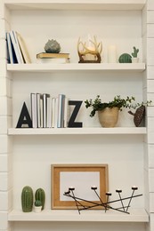Many shelves with different decor in room. Interior design