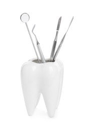 Tooth shaped holder with dental tools on white background