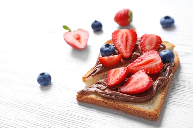 Toast bread with strawberry and blueberry on light background, closeup