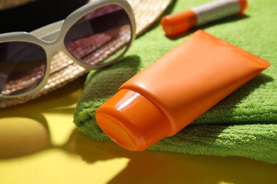 Photo of Tube of sun protection cream on towel, closeup