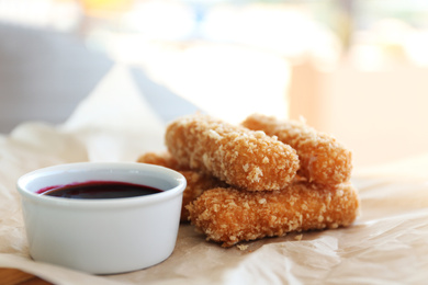 Fried cheese sticks and sauce on parchment