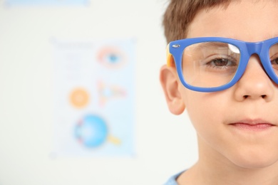 Cute little boy with glasses visiting ophthalmologist