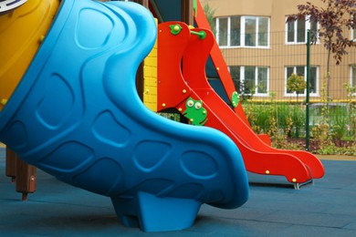 Colourful slides on outdoor playground for children in residential area