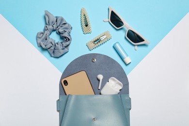 Stylish women's bag and different stuff on color background, flat lay