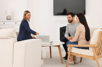 Photo of Real estate agent consulting couple in new apartment