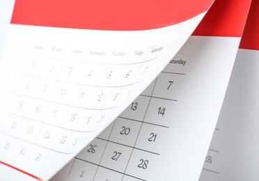 Paper calendar with turning pages as background, closeup