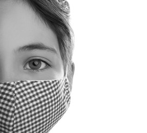 Girl wearing medical face mask on light background, closeup. Black and white photography