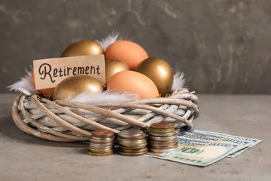 Different eggs, money and card with word Retirement on grey table. Pension concept