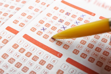 Filling out lottery ticket with pen, closeup. Space for text