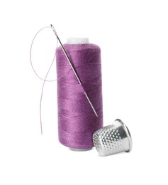 Spool of thread and sewing tools on white background