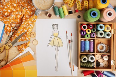 Sketch of fashion dress and thread supplies at designer's workplace, flat lay