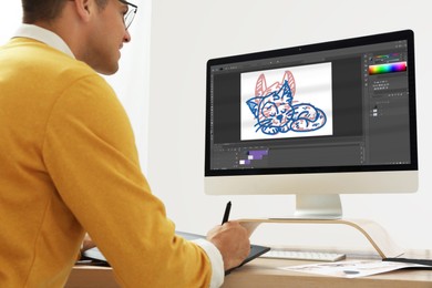 Image of Animator working with graphic tablet and computer. Illustration on screen