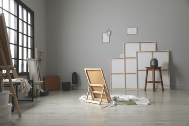Photo of Stylish artist's studio interior with canvas and brushes