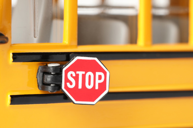 Photo of Yellow school bus, focus on stop sign. Transport for students