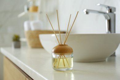 Reed air freshener on counter in bathroom