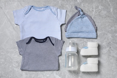 Flat lay composition with cute baby items on grey background