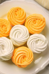 Image of Delicious white and orange zephyrs on plate, top view