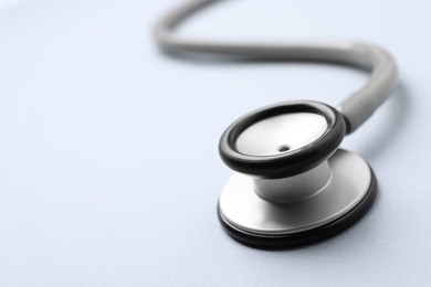 Stethoscope on white background, closeup. Space for text