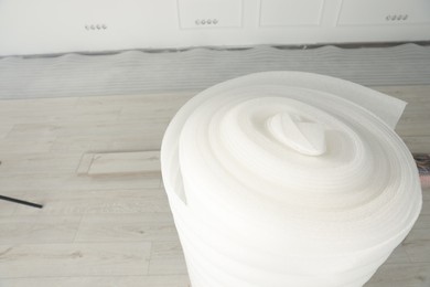 Roll of polyethylene foam in room prepared for renovation, closeup