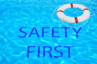 Safety first. Life buoy in swimming pool with clean blue water 