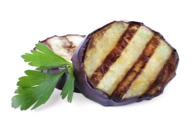 Delicious grilled eggplant slices and parsley on white background