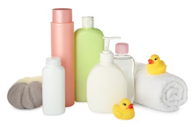 Bottles of baby cosmetic products, towel, bath sponge and rubber ducks on white background